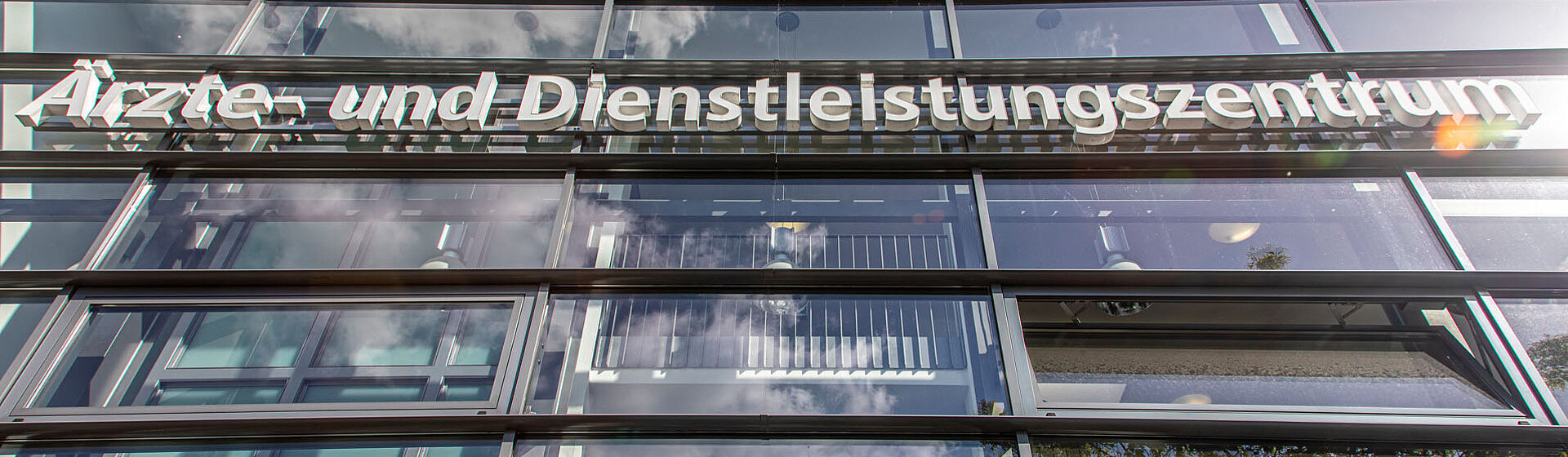 Weißer Schriftzug Ärzte- und Dienstleistungszentrum am Gebäude.