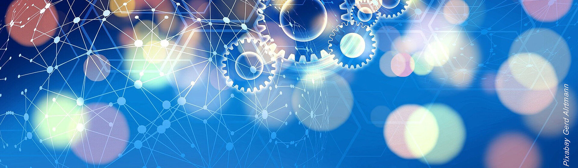 Zahnrädergrafik, im Hintergrund verschwommene bunte Lichter